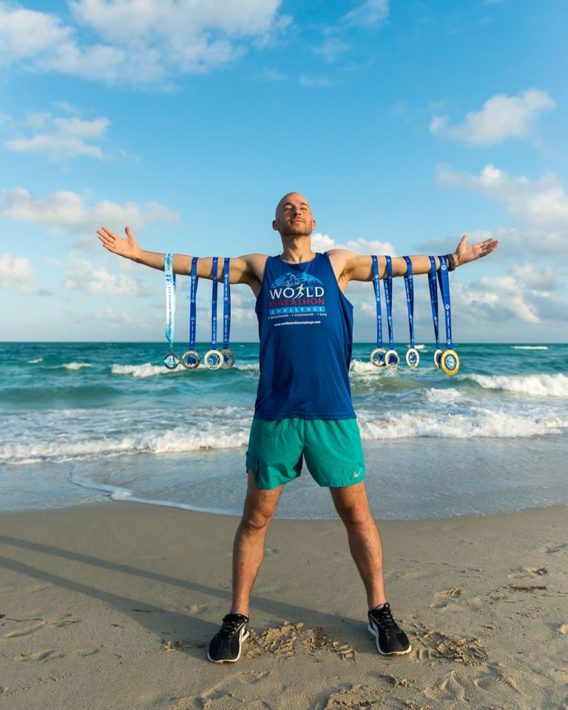 Jared Blank and his 7 medals, completing the World Marathon Challenge